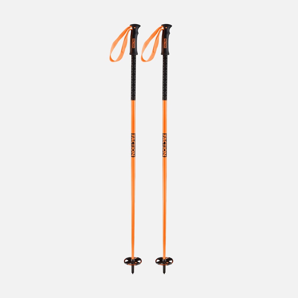 Pair of orange Faction ski poles with black ergonomic grips, orange wrist straps, and black snow baskets.