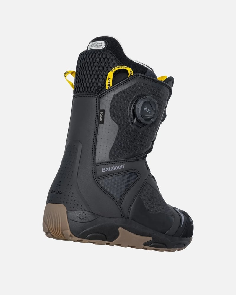 Rear view of a black and grey Bataleon Women's Rave Double Boa snowboard boot with yellow accents and a gum sole.